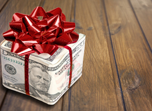 Box Made Of Money Wrapped In A Red Bow