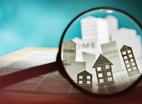 A Magnifying Glass Overlooking Houses