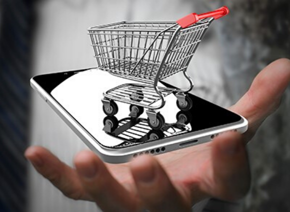 Shopping Cart On A Smartphone Being Held In A Hand