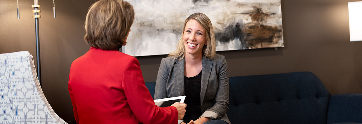 Woman holding a tablet conducting a job interview with another woman
