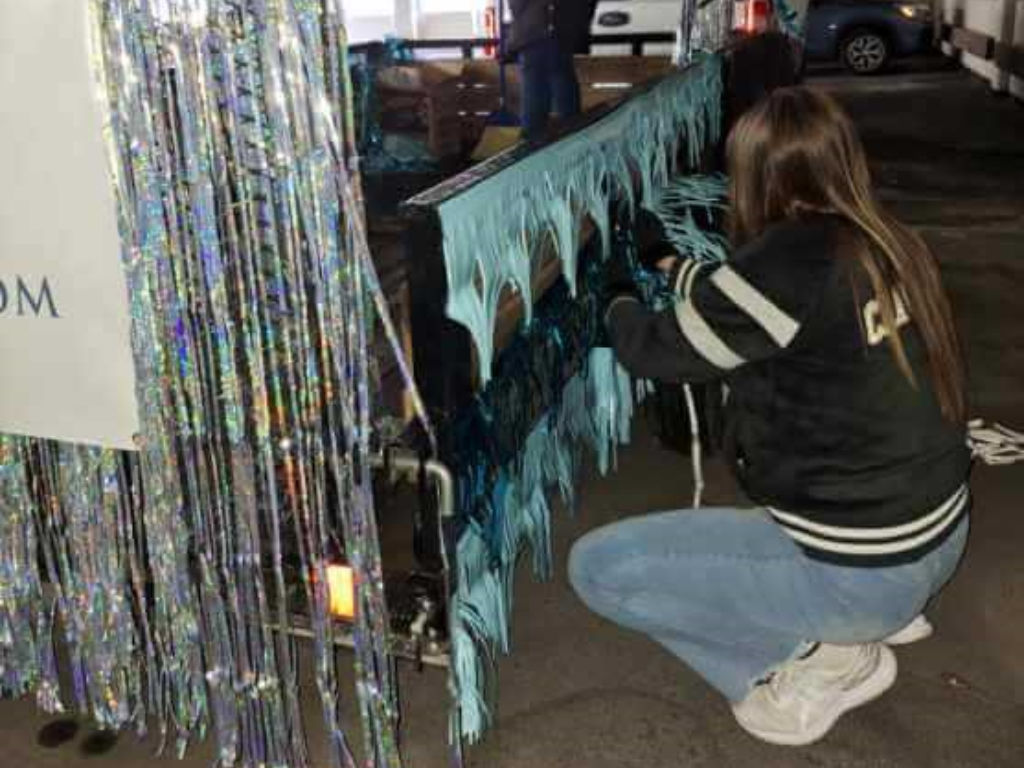 Individual Putting Tinsel On A Trailer For The Float