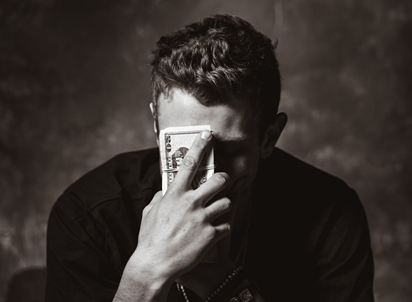 Man Holding Cash On Forehead