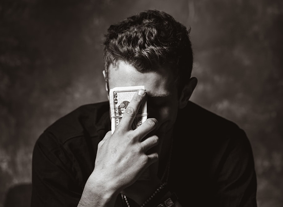 man holding cash on forehead