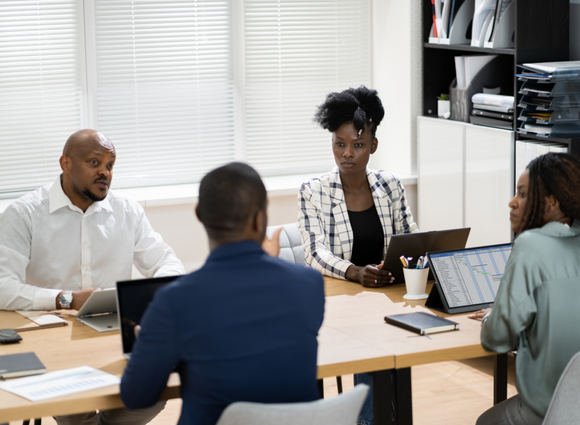 Group Of Young Professionals Meet Around A Table