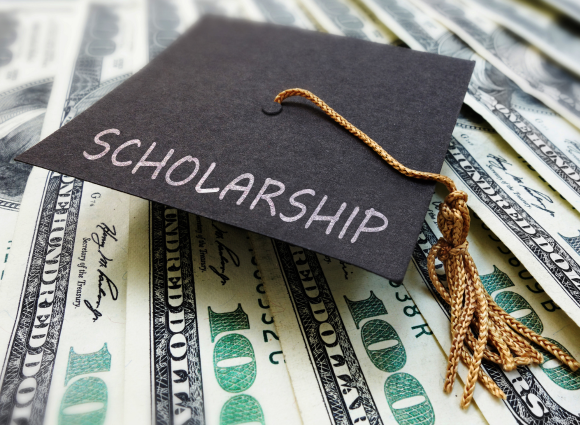 Photo Of A Graduation Cap Sitting On Top Of Money