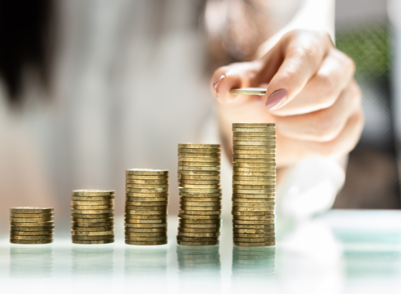 Photo Of Person Stacking Coins In A Row