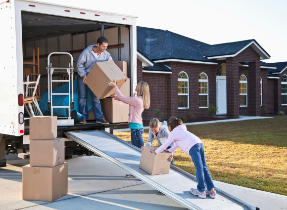 Photo Of Family Loading Boxes Into A Moving Truck