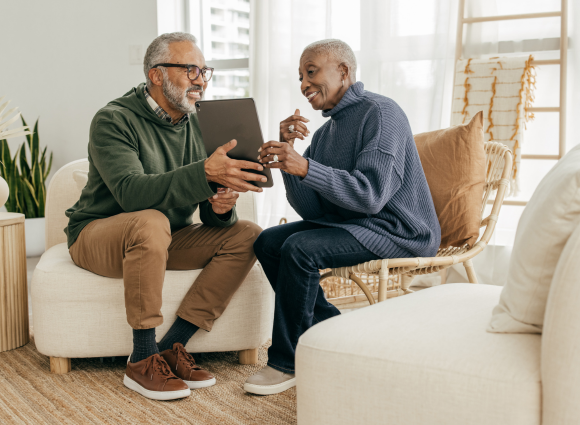 Photo Of Couple Discussing Something Over An Ipad