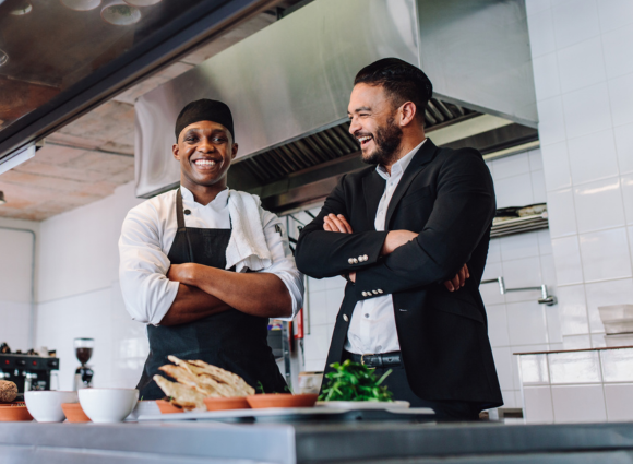 Photo Of Restaurant Owner Having A Friendly Conversation With His Chef